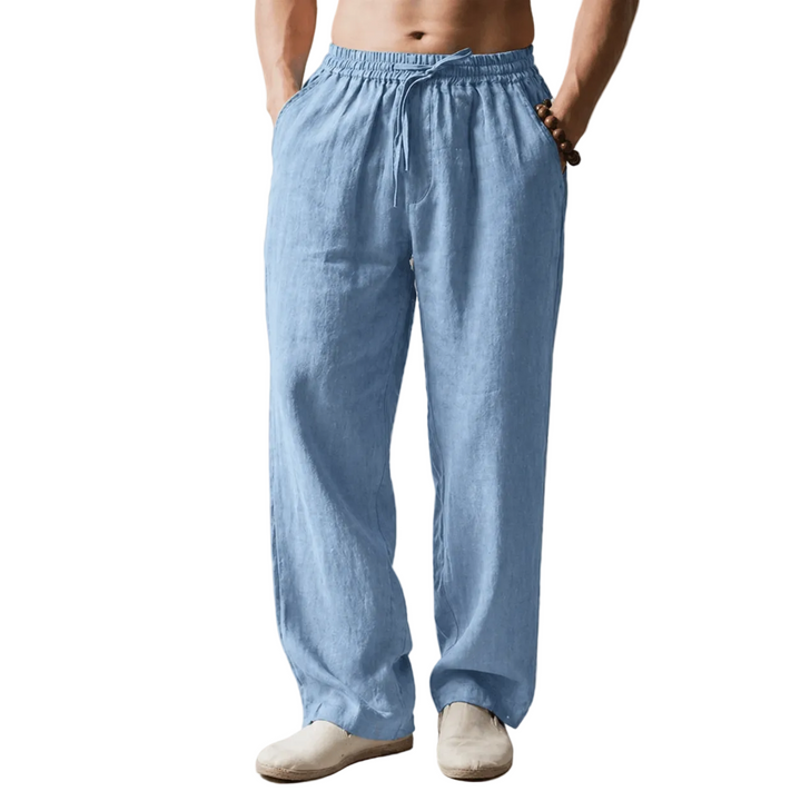 Person wearing light blue linen pants against a white background