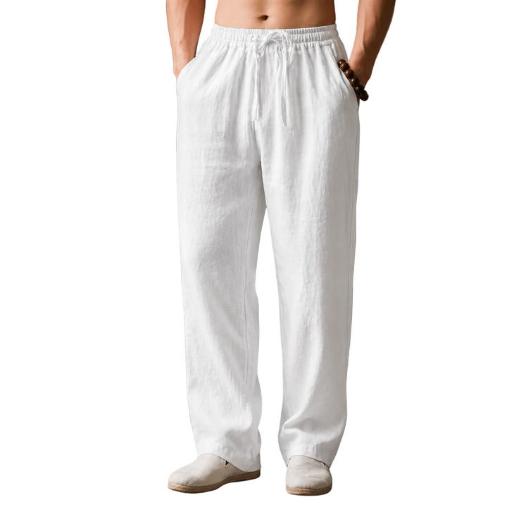 Person wearing white linen pants against a white background