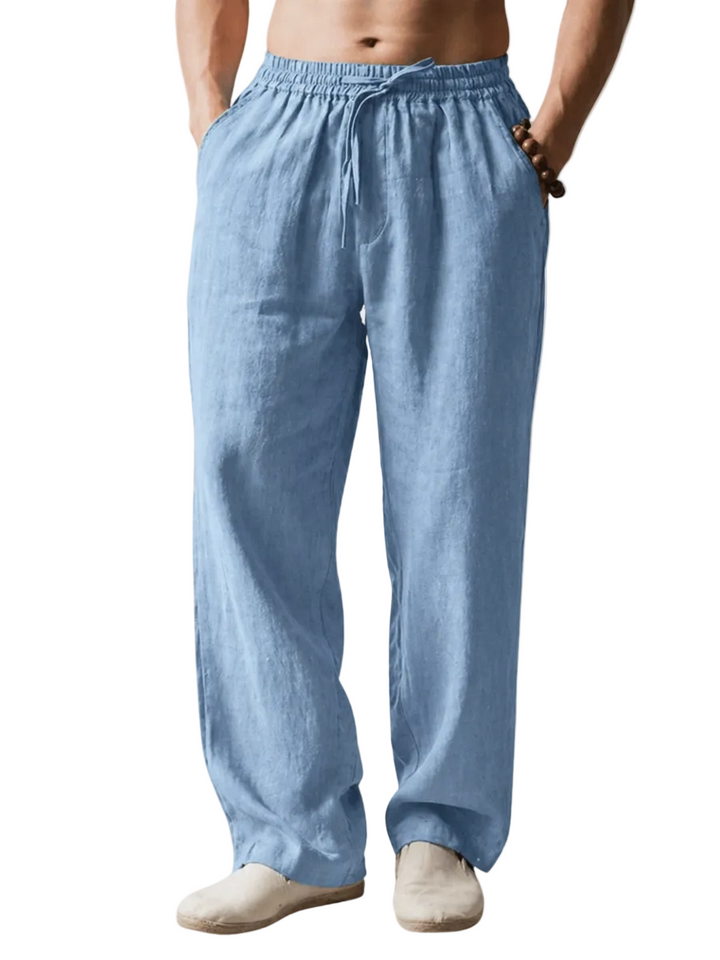 Light blue linen pants worn by a person on a white background
