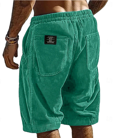 Green corduroy shorts with a brand label on a white background