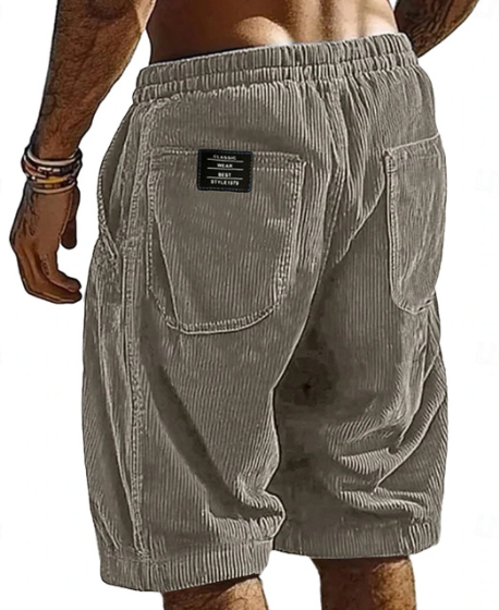 Beige shorts with a brand label on a white background