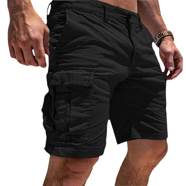 Black cargo shorts worn by a person on a light white background