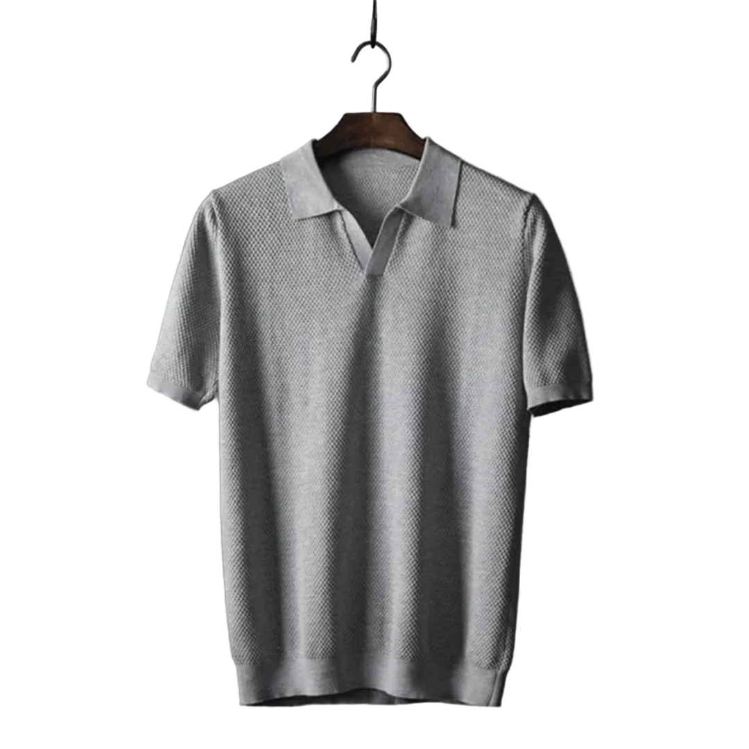 Gray polo shirt on a wooden hanger against a white background