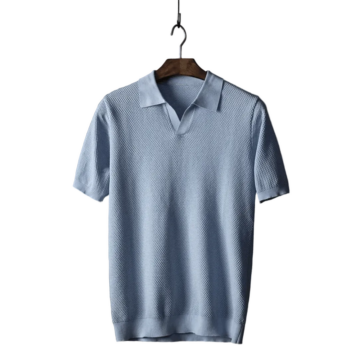 Light blue polo shirt on a wooden hanger against a white background