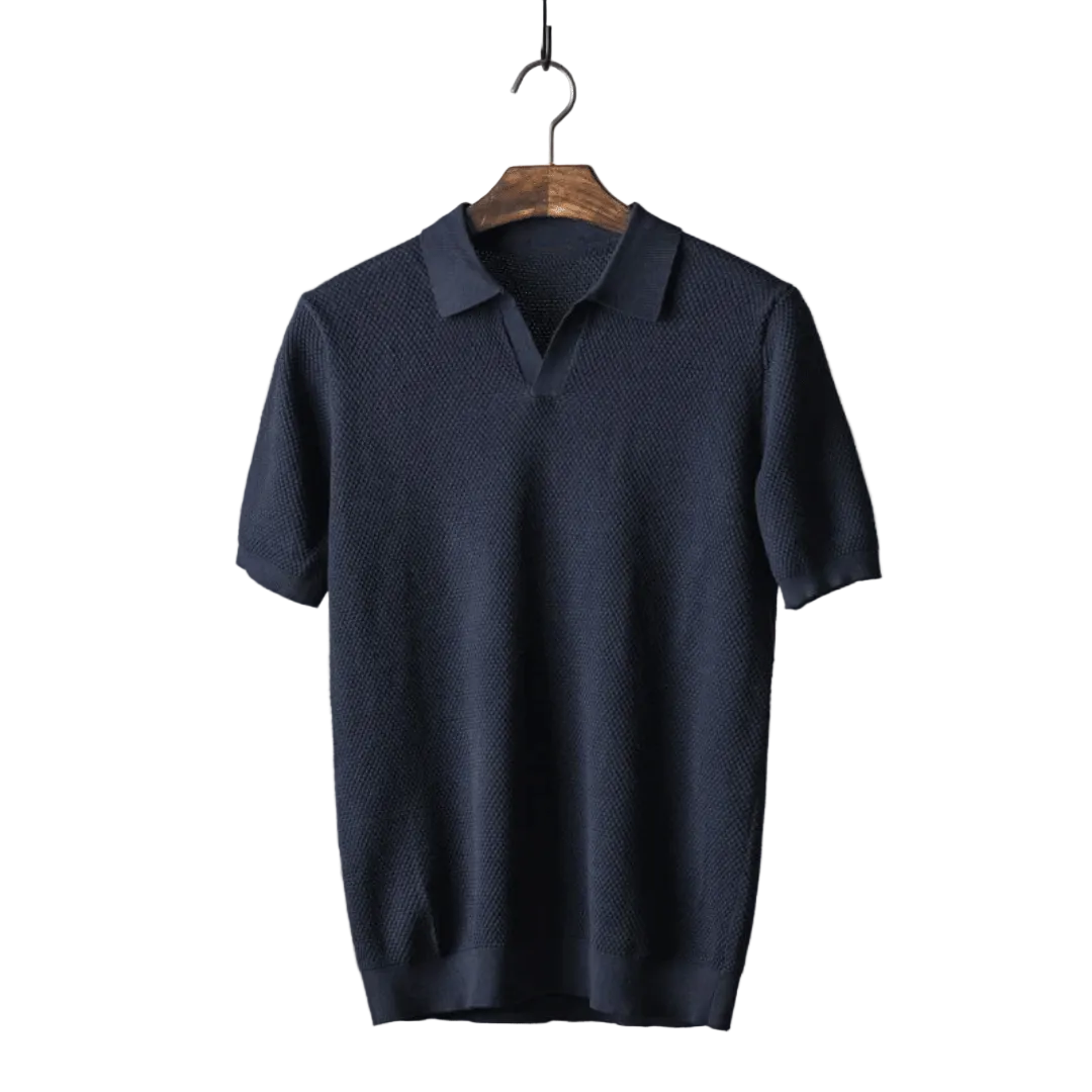Navy blue polo shirt on a wooden hanger against a white background