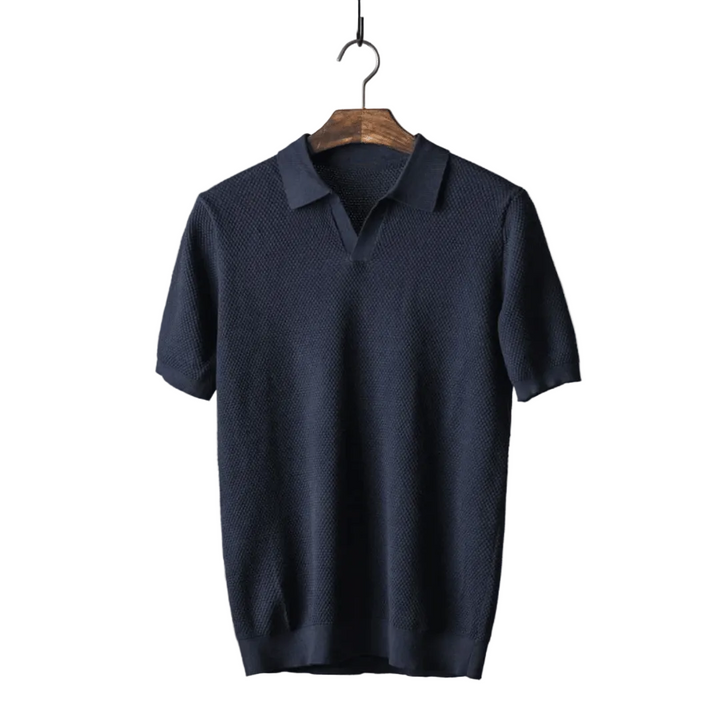 Navy blue polo shirt on a wooden hanger against a white background