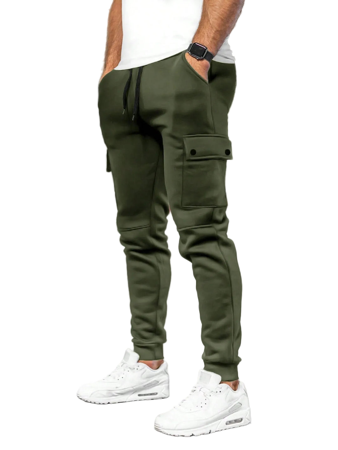 Person wearing green cargo jogger pants and white sneakers in a white background.