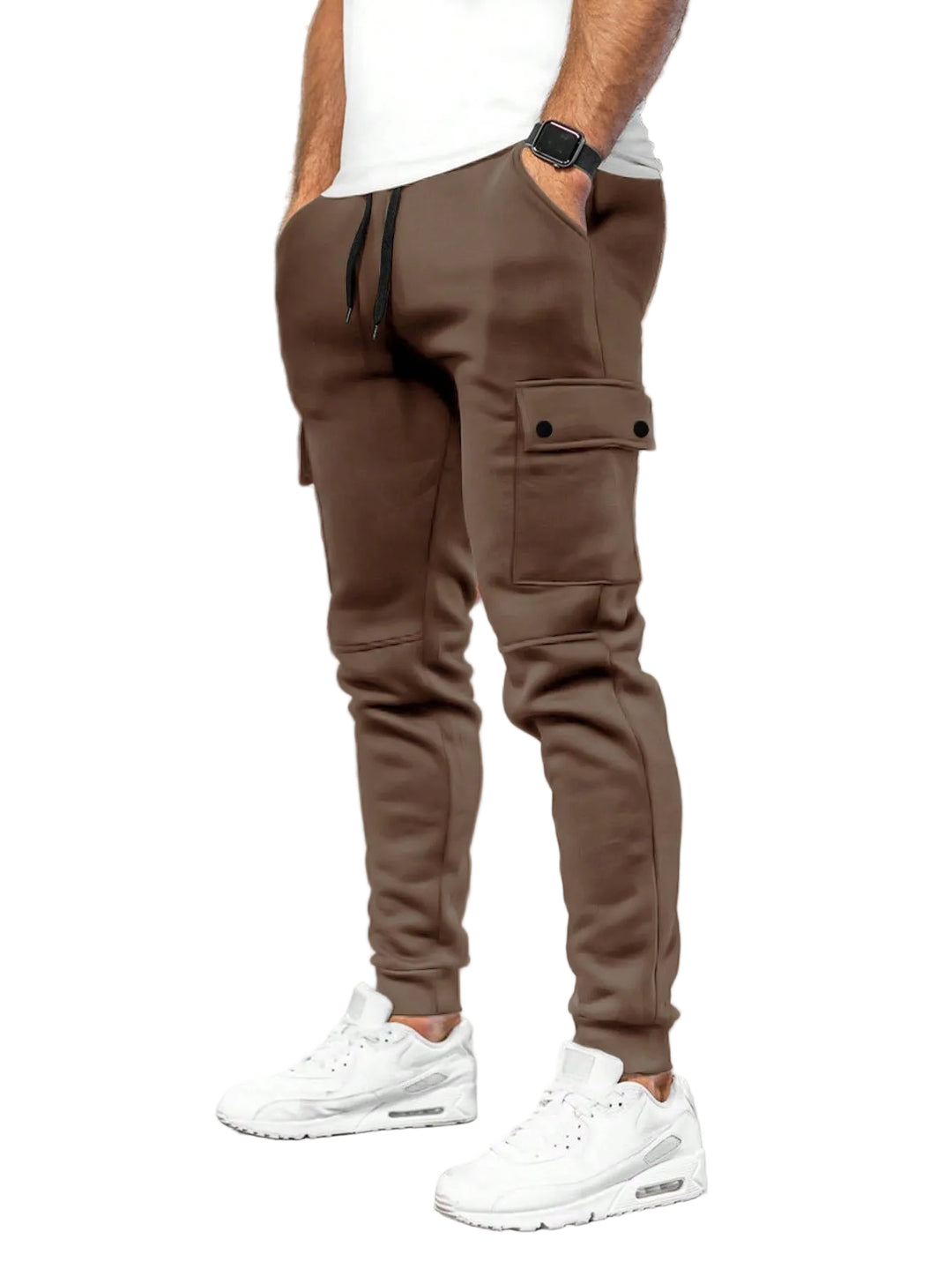 Person wearing brown cargo jogger pants and white sneakers in a white background.