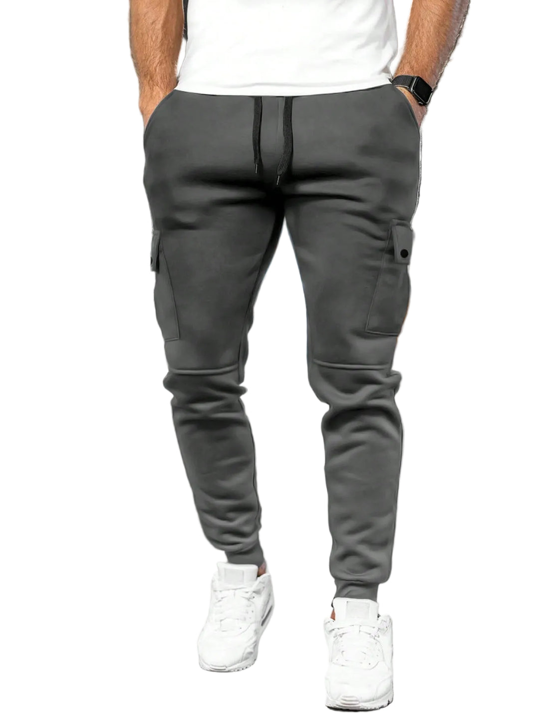 Person wearing gray cargo jogger pants and white sneakers in a white background.