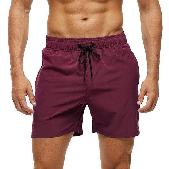 Maroon shorts with a drawstring on a white background
