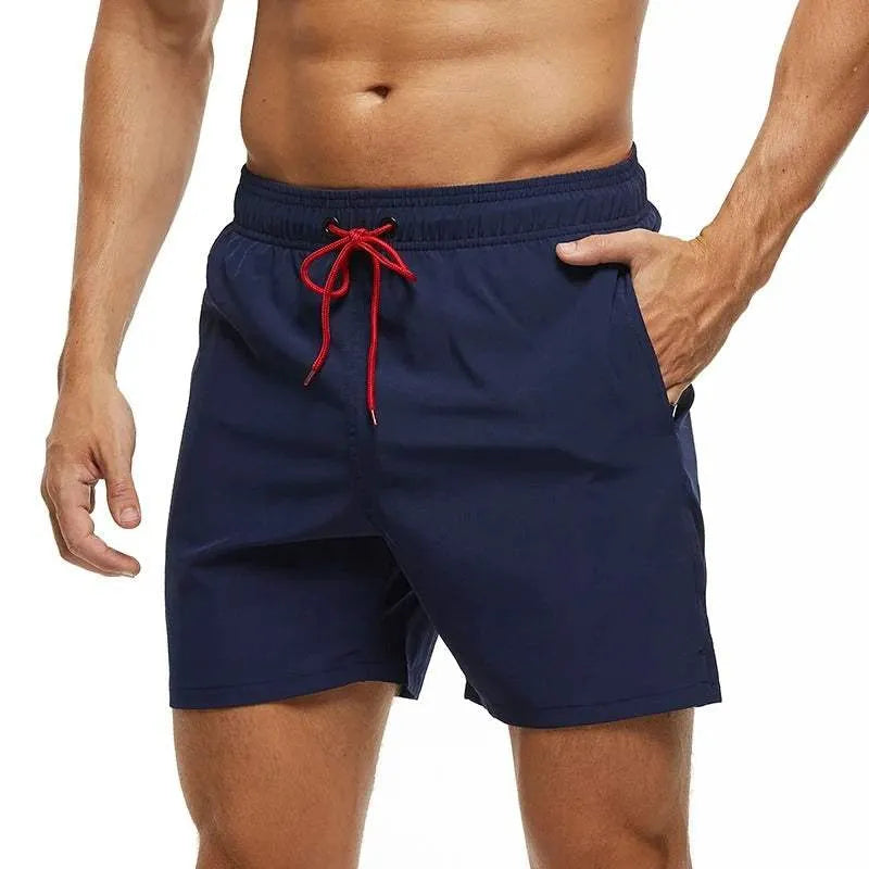 Navy blue shorts with a red drawstring on a white background