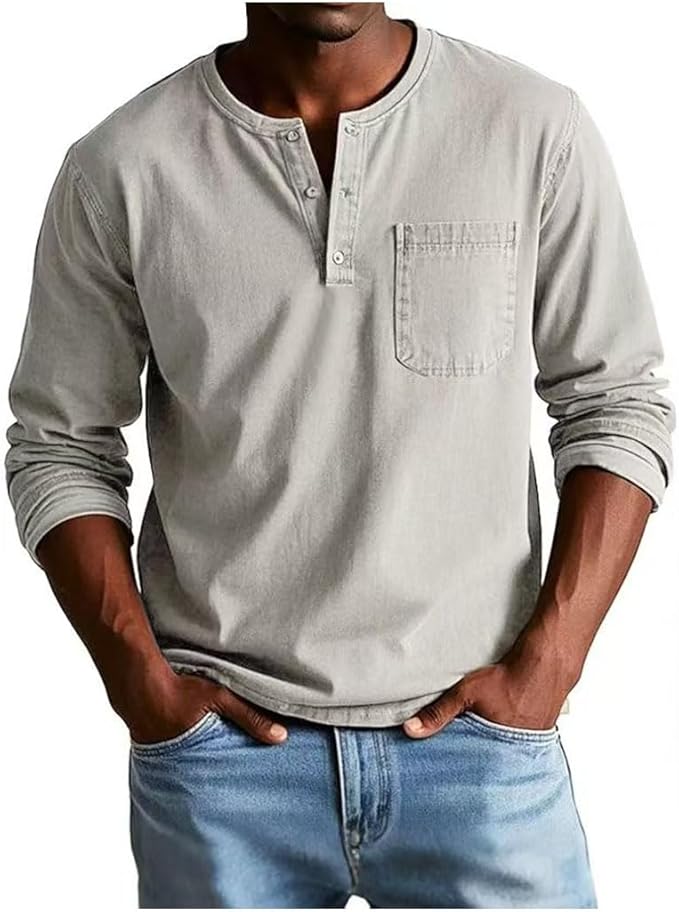 Man wearing a light gray long-sleeve henley shirt and blue jeans on a white background