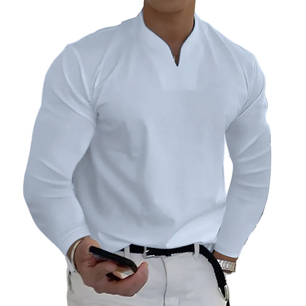 Person wearing a light blue long-sleeve shirt and white pants against a white background