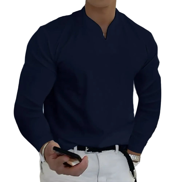 Person wearing a black long-sleeve shirt and white pants, holding a phone.