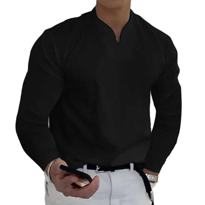 Person wearing a black long-sleeve shirt and white pants, holding a phone.