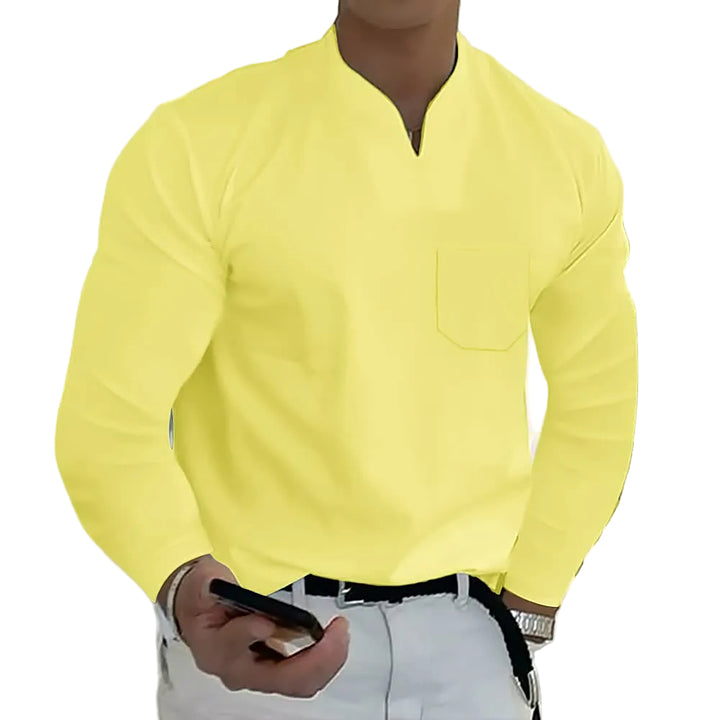 Person wearing a bright yellow long-sleeve shirt with a plain background