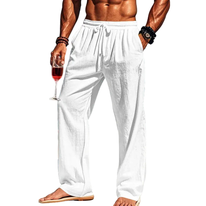 Man in white pants holding a glass of red wine with white background