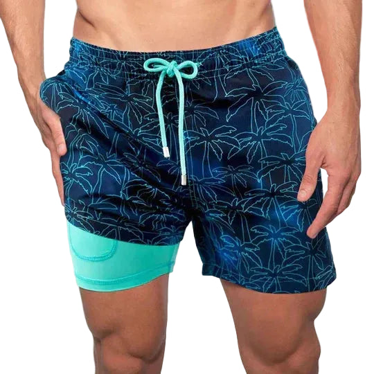 Person wearing blue and green patterned swim shorts on a white background.