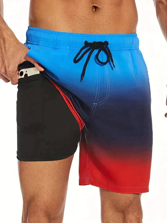 Gradient blue, black, and red swim shorts with a drawstring on a white background.