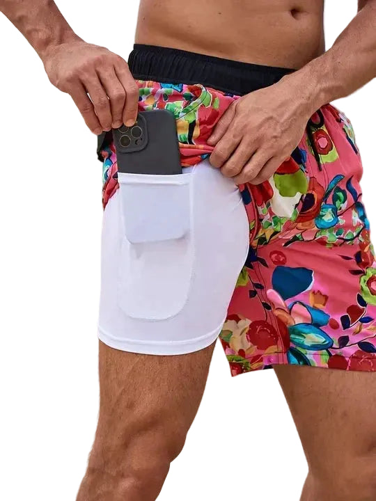 Colorful swim shorts with a white pocket on a white background.