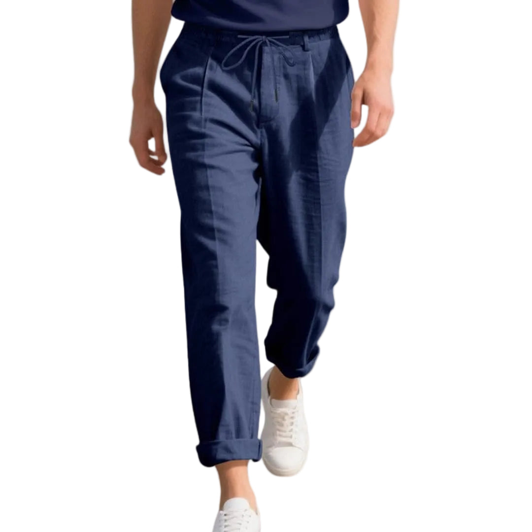 Person wearing navy blue pants with a white background