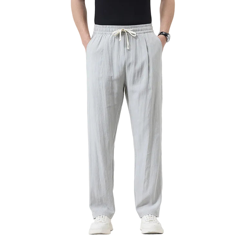 Person wearing light gray pants on a white background