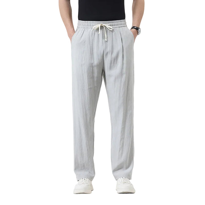 Person wearing light gray pants on a white background