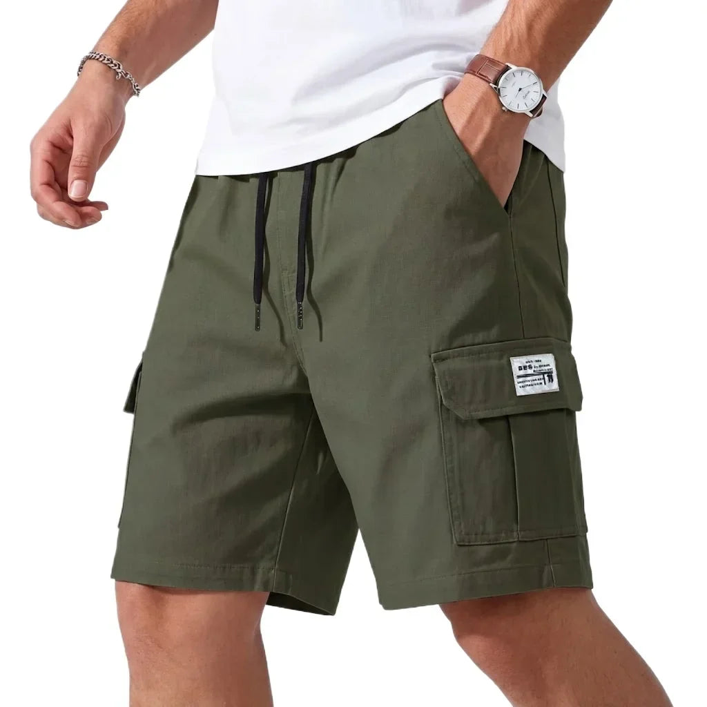 Green cargo shorts worn by a person on a white background