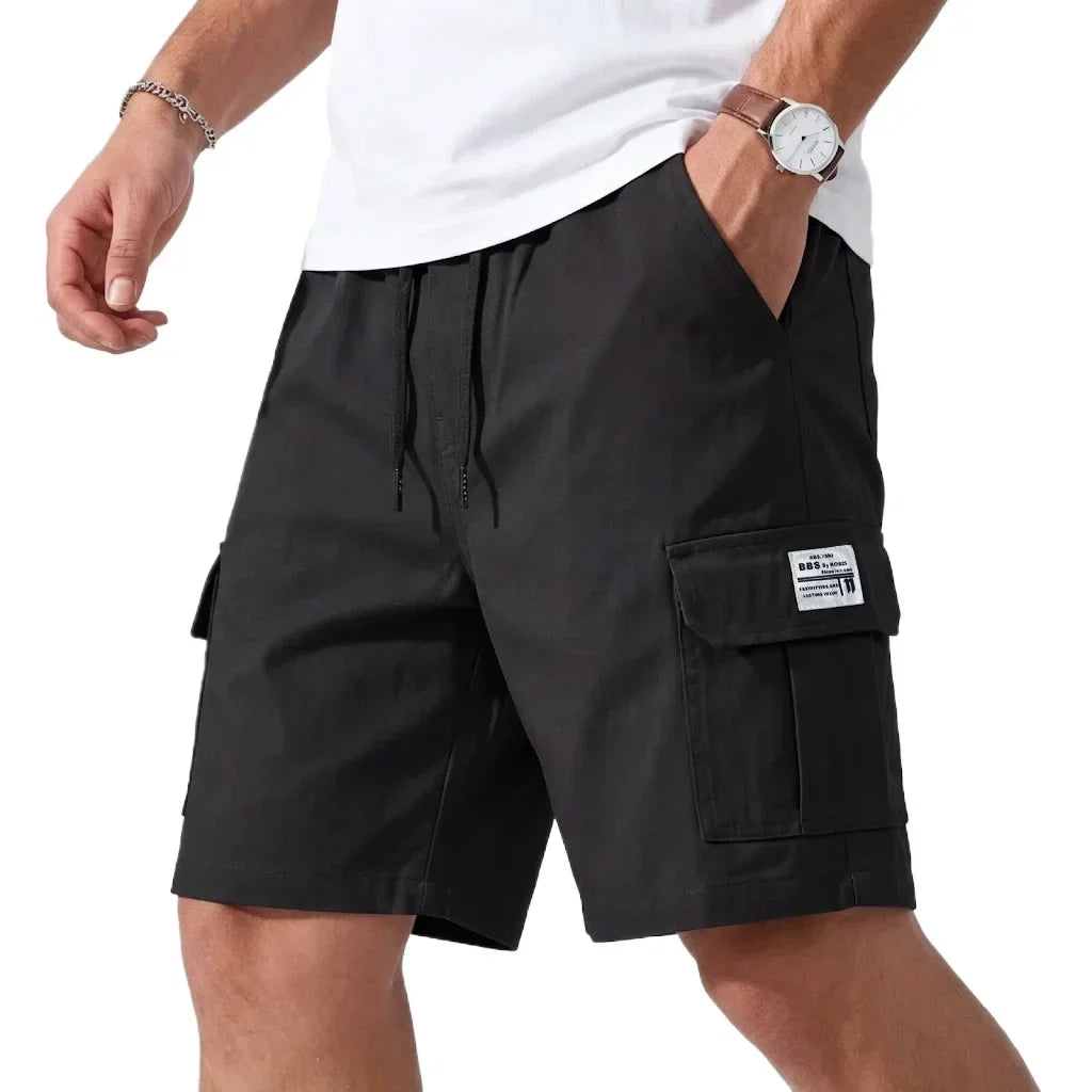 Navy blue cargo shorts worn by a person on a white background