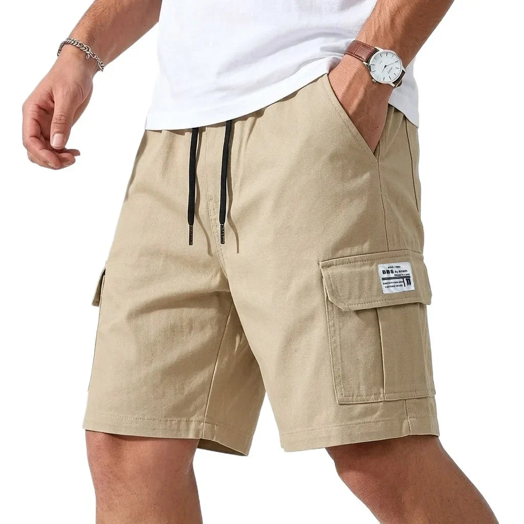Beige cargo shorts worn by a person on a white background