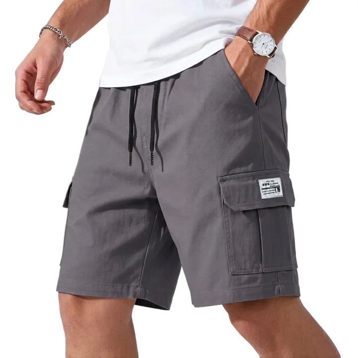 Gray cargo shorts worn by a person on a white background