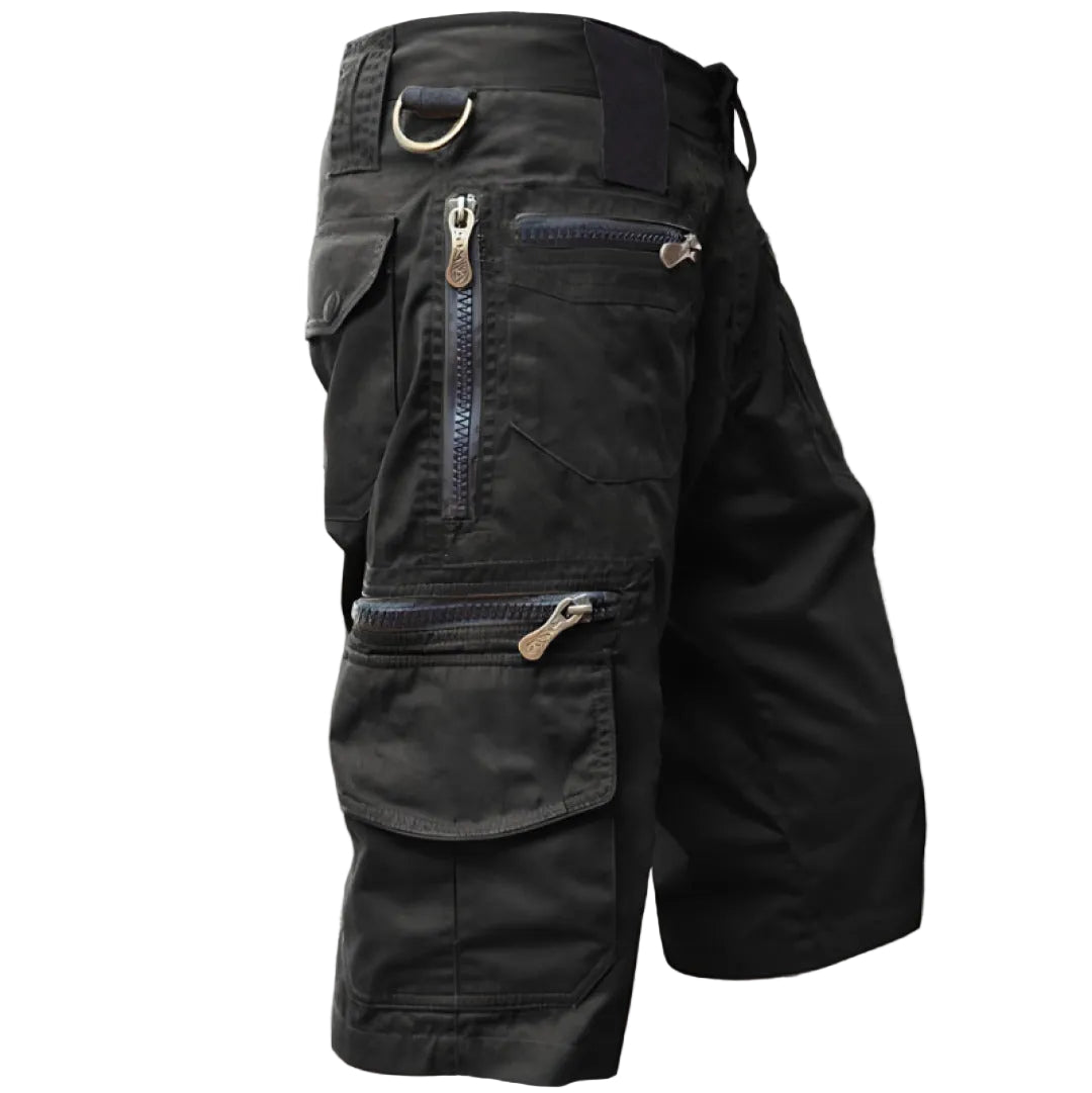 Black tactical pants with multiple pockets and zippers on a white background