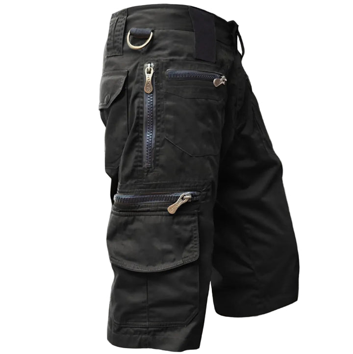 Black tactical pants with multiple pockets and zippers on a white background