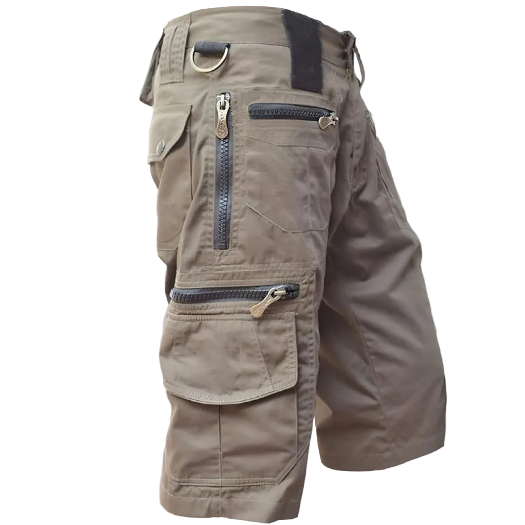 Brown cargo shorts with multiple pockets and zippers on a light white background