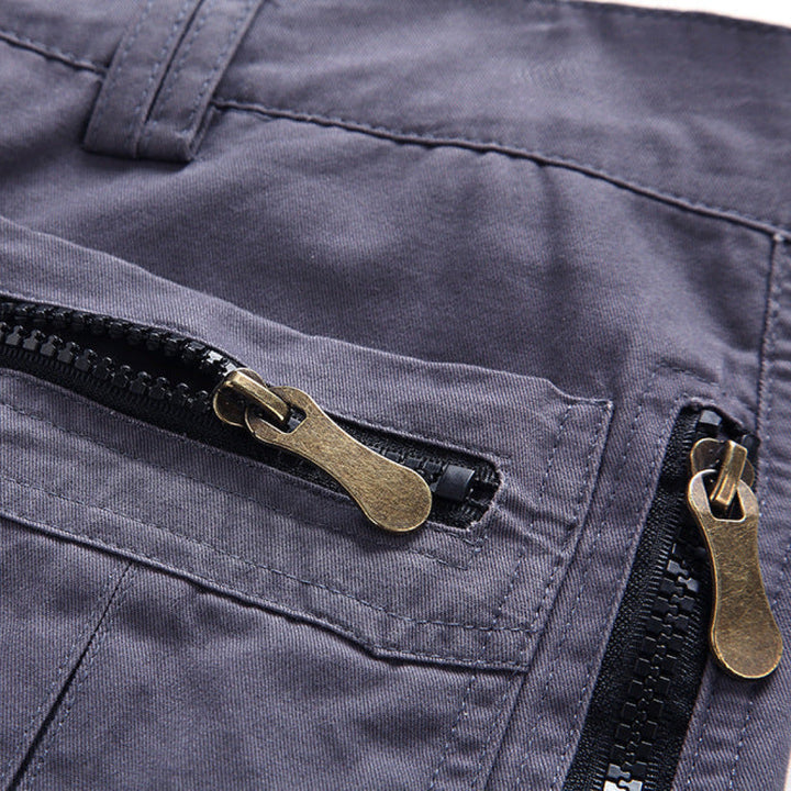Close-up of a navy blue jacket with brass zippers and black zipper pulls.