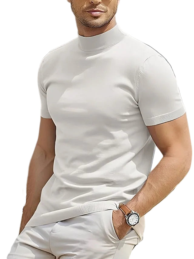Man wearing a white turtleneck sweater and pants with a white background