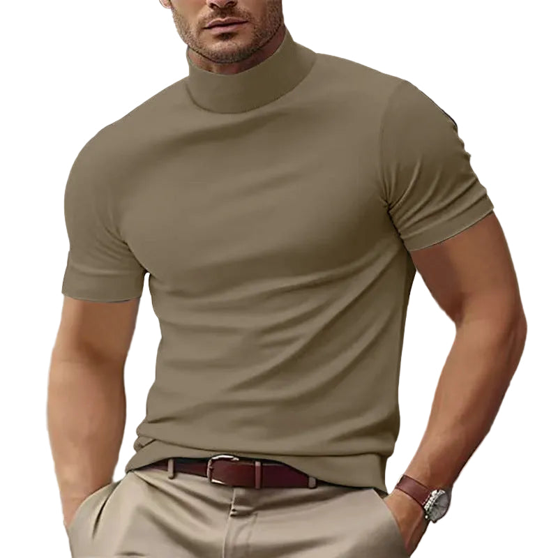 Man wearing a beige turtleneck and pants with a white background