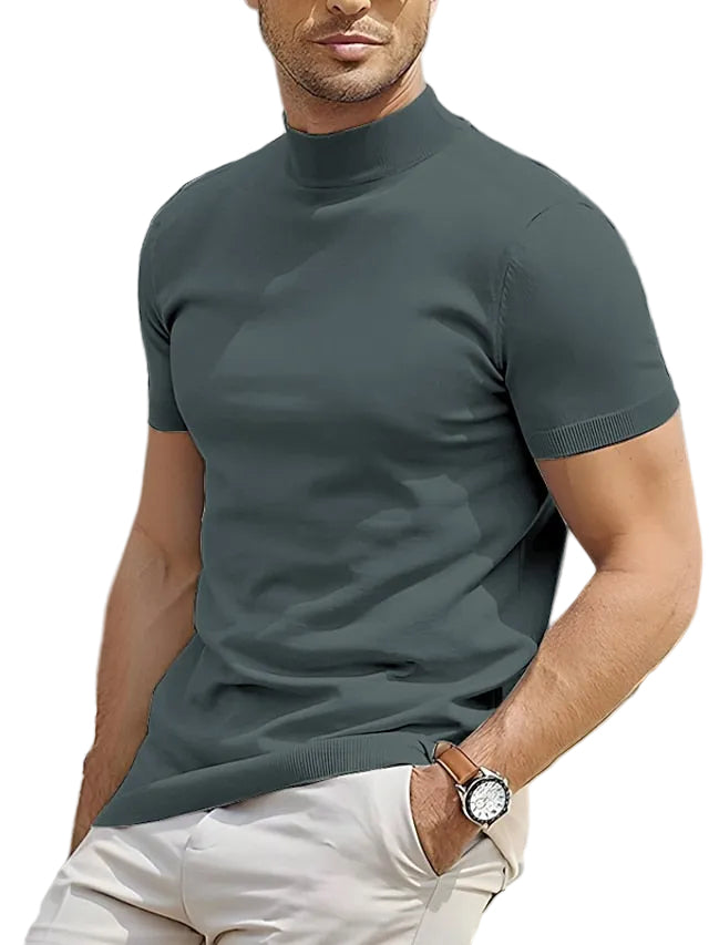 Man wearing a dark green turtleneck sweater with a white background