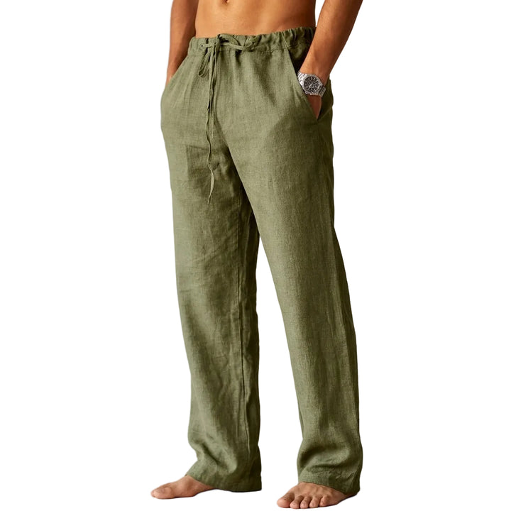 Person wearing olive green linen pants against a plain background