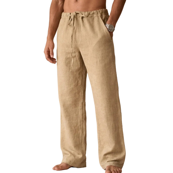 Beige linen pants worn by a person on a white background
