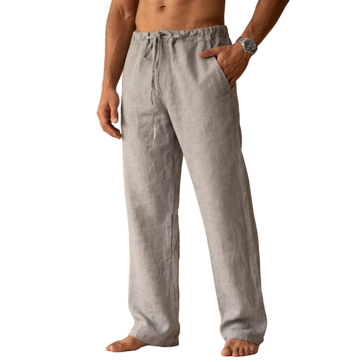 Man wearing light gray linen pants against a white background