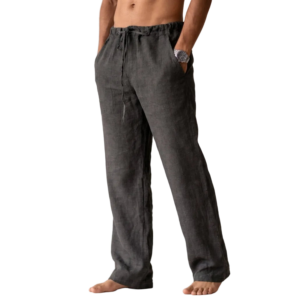 Person wearing dark gray linen pants on a plain background